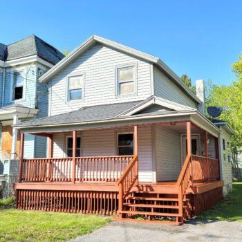 A two-storey house with a new front deck on Putnam Street, Syracuse