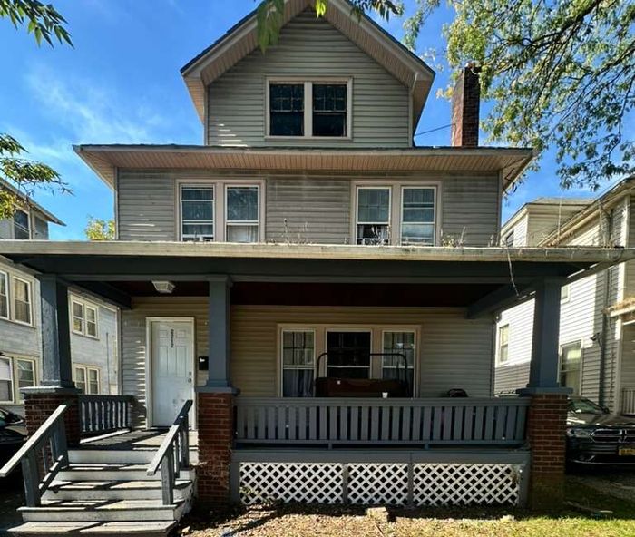A foursquare house with a wide covered porch on Midland Avenue, Syracuse